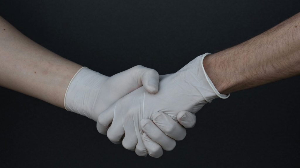 person holding white heart shaped paper